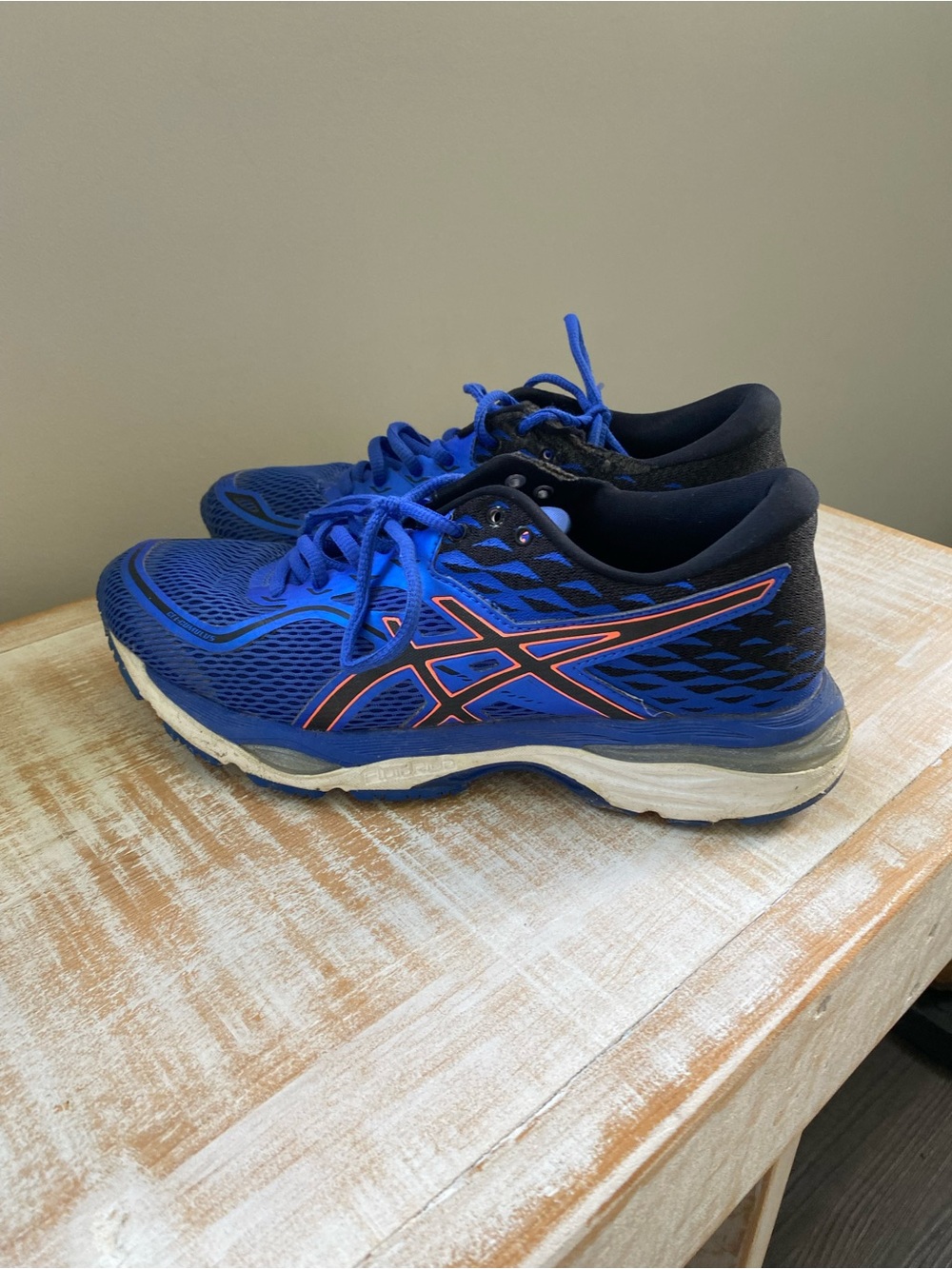 ASICS women’s Blue Running Shoes with Orange Accents